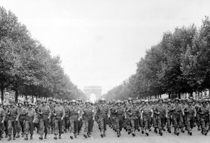 By definition, moving a large grouip 'by their hosts' requires organization and leaders. Exampled here in picture are Americans troops marching down the Champs Elysees upon the liberation of Paris.